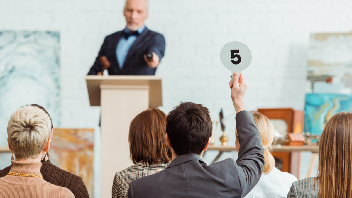 Back,View,Of,Buyer,Showing,Auction,Paddle,With,Number,Five